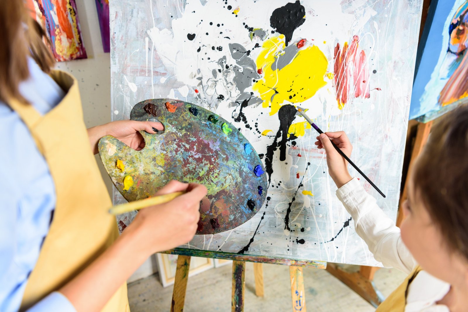 cropped-image-of-pupil-painting-on-lesson-in-workshop-of-art-school.jpg